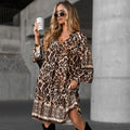 Elegant, printed dress with a V-neck and long sleeves